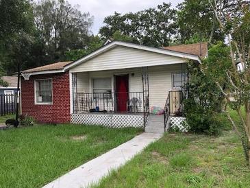 Charming one-story home featuring a brick accent, front porch, and a cozy, inviting curb appeal at 6201 N 38Th St, Tampa, FL 33610