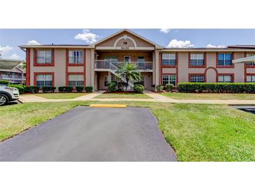 Inviting two-story condo showcasing well-maintained landscaping and convenient parking at 6428 Gloria Dr # 21, New Port Richey, FL 34653