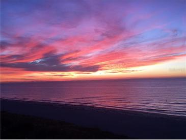 Beautiful sunset over the ocean with vibrant pink and orange colors reflecting on the water at 1390 Gulf Blvd # Ph-5, Clearwater, FL 33767