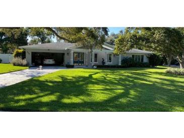 Charming single-story home with well-manicured lawn and covered carport at 209 Rosery Rd, Belleair, FL 33756