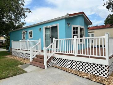 Charming turquoise home with a welcoming deck and white lattice trim at 21034 Lirio Dr, Land O Lakes, FL 34637