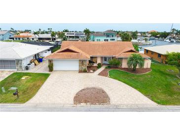 Charming single-story home featuring a beautiful terracotta roof and a spacious circular driveway at 5008 Southshore Dr, New Port Richey, FL 34652