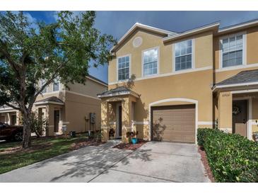 Charming two-story townhome with neutral stucco exterior, single car garage, and manicured front lawn in a quiet neighborhood at 6902 47Th N Ln, Pinellas Park, FL 33781