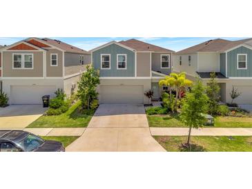 Charming two-story home with well-manicured lawn and a two car garage at 12950 Pasture Woods Pl, Lithia, FL 33547