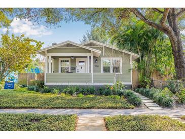 Charming single-story home with green siding, manicured lawn, and a welcoming front porch at 2710 2Nd N Ave, St Petersburg, FL 33713