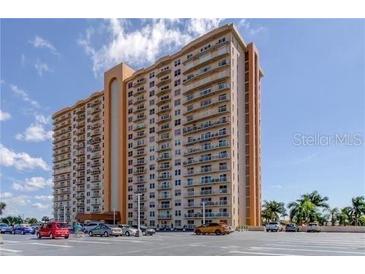 Image of a luxury high-rise condominium building with a beige facade and private balconies for each unit at 4900 Brittany S Dr # 1810, St Petersburg, FL 33715