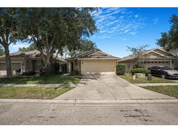 Charming single Gathering home with a well-maintained lawn and inviting curb appeal at 7031 Kendall Heath Way, Land O Lakes, FL 34637
