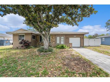 Charming single-story home with mature landscaping, a driveway, and a one-car garage at 109 S Nimbus Ave, Clearwater, FL 33765