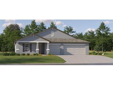 Beautiful single-story home featuring a three-car garage, manicured lawn, and classic architectural details at 13167 Violet Flame Ave, Wimauma, FL 33598