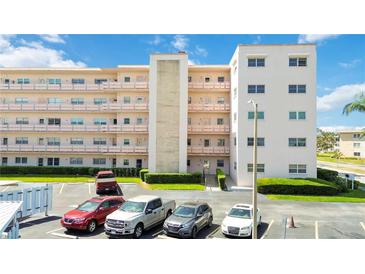 Exterior of building with multiple levels, balconies, parking lot and landscaping at 5623 80Th N St # 202, St Petersburg, FL 33709
