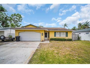 Charming single-story home with a front yard, white garage door, and classic design at 5920 Denver Ne St, St Petersburg, FL 33703