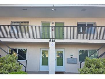 Two-story condo building featuring well-maintained landscaping and a secure entrance at 614 Guild Dr # 15, Venice, FL 34285