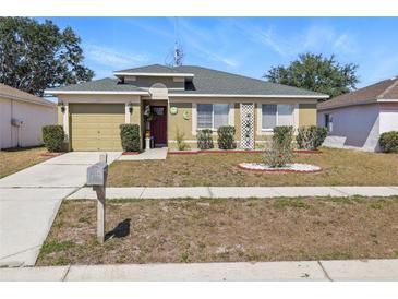 Charming single-story home featuring a well-maintained lawn and a cozy, inviting entrance at 13308 Prestwick Dr, Riverview, FL 33579