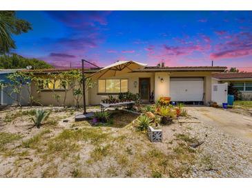 Charming single-story home with a cozy front yard featuring a lovely garden and a covered entrance at 2078 Shadow Ln, Clearwater, FL 33763
