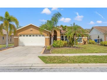 Charming single-story home featuring a well-manicured lawn and attached two-car garage at 4410 Foxboro Dr, New Port Richey, FL 34653