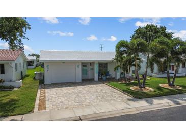 Charming single-story home with a manicured lawn, beautiful driveway, and inviting curb appeal at 9743 36Th N Way # 4, Pinellas Park, FL 33782