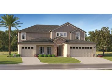 A beautifully built two-story home featuring a two-car garage, manicured lawn, and a combination of stone and siding details at 11837 Blue Diamond Trl, Parrish, FL 34219