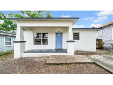 Charming single-story home featuring a welcoming front porch and light blue entry door at 2921 N 18Th St, Tampa, FL 33605