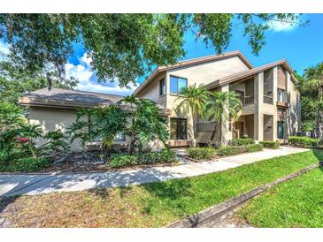 Inviting two-story home with well-maintained landscaping and a welcoming walkway at 3079 Landmark Blvd # 1608, Palm Harbor, FL 34684