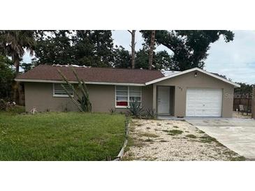 Charming single-story home featuring a well-maintained lawn and a classic garage door at 192 Tulane Rd, Venice, FL 34293