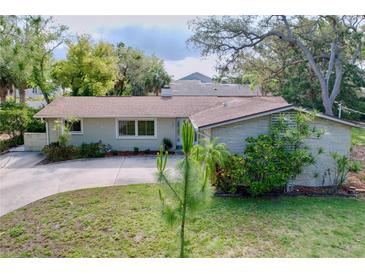 Charming single-story home featuring a well-maintained lawn, inviting curb appeal, and beautiful landscaping at 232 Pinecrest Dr, Palm Harbor, FL 34683