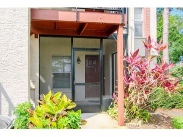 Charming screened front porch with decorative plants welcomes you to this lovely home at 3455 Countryside Blvd # 31, Clearwater, FL 33761