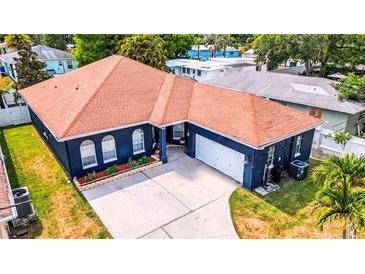 Charming single-story home featuring an attached garage and manicured front yard landscaping at 650 Arbor Ln, Largo, FL 33770