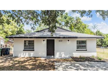 Charming single-story home featuring updated paint, landscaping and exterior lighting at 8107 N 11Th St, Tampa, FL 33604