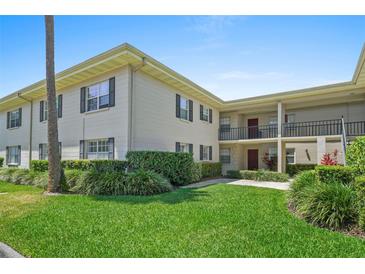 Beautiful exterior of home with lovely landscaping, trimmed hedges, and lush green grass at 2207 S Carolina Ave # 7, Tampa, FL 33629