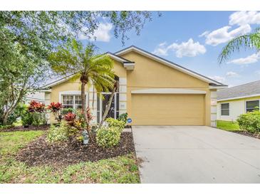 Charming single-story home with a well-manicured lawn and vibrant landscaping at 5205 Lansdowne Way, Palmetto, FL 34221