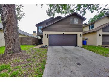 Charming two-story home featuring a spacious driveway and lovely exterior, perfect for a Gathering at 13703 Sweetwater Cove Pl, Tampa, FL 33613