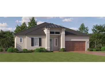 Charming single-story home with a symmetrical facade, a two-car garage, and lush landscaping at 31670 Cannon Rush Dr, San Antonio, FL 33576