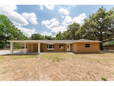 Charming brick home featuring a covered carport, bay window, and a well-maintained front yard with mature trees at 4323 Culbreath Rd # B, Valrico, FL 33596