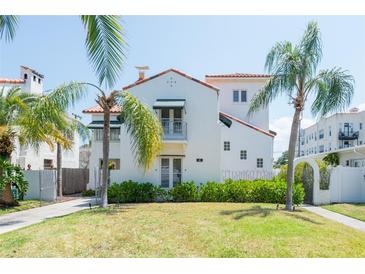 Beautiful view of home with lush landscaping, and iconic palm trees with a red tile roof at 53 Albemarle Ave, Tampa, FL 33606