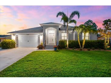 Charming home with lush green lawn, well-maintained landscaping, and a welcoming two-car garage at 6121 33Rd N Ave, St Petersburg, FL 33710