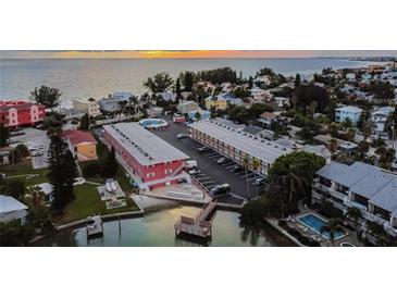 Stunning aerial view showcases the property's prime waterfront location, pool, and surrounding neighborhood at 8565 W Gulf Blvd # 21S, St Petersburg, FL 33706