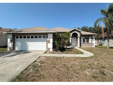 Charming single Gathering home with arched entryway and two-car garage at 1145 Riveredge Dr, Tarpon Springs, FL 34689
