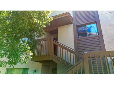 An inviting exterior entrance featuring well-maintained stairs and neutral color scheme at 12804 Wedgewood Way # C, Hudson, FL 34667