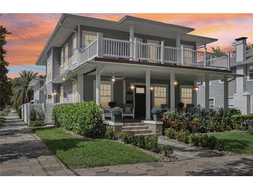 Charming two-story home with a beautiful landscaped yard and inviting front porch and balcony at 157 9Th N Ave, St Petersburg, FL 33701