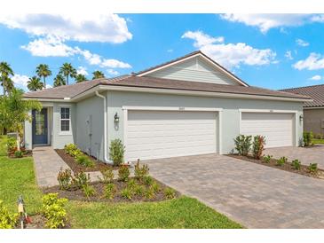 Charming single-story home boasts a well-manicured lawn, paved driveway, and a convenient two-car garage at 20417 Symphony Pl, Venice, FL 34293