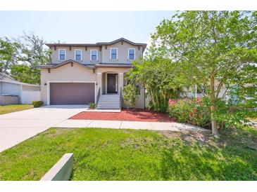 Charming two-story home featuring a well-maintained lawn and a two-car garage at 7307 S Morton St, Tampa, FL 33616