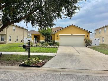 Inviting single-story home featuring a well-maintained lawn and attached two-car garage at 10607 Boyette Creek Blvd, Riverview, FL 33569