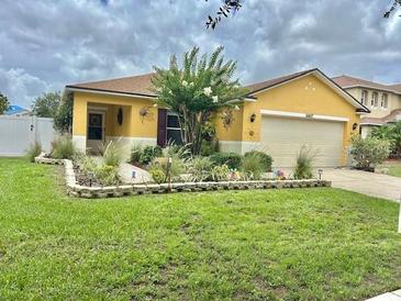 Charming single-Gathering home featuring a well-maintained lawn and beautiful landscaping at 10607 Boyette Creek Blvd, Riverview, FL 33569