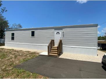 Charming single-story home featuring a freshly painted exterior and a newly built wood staircase at 11351 Edison Ave, New Port Richey, FL 34654
