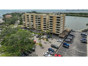 An exterior of the condo building showcasing a parking area and nearby waterway and some water views at 5701 Mariner St # 701, Tampa, FL 33609