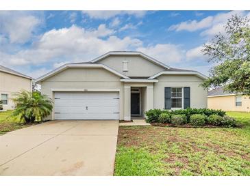 Charming single-story home with a well-manicured lawn and a two-car garage at 3876 Crossline Dr, Spring Hill, FL 34609
