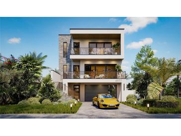 Contemporary three-story home featuring a stone accent wall, balconies, and a two-car garage with a yellow sports car at 4322 26Th S Ave, Gulfport, FL 33711
