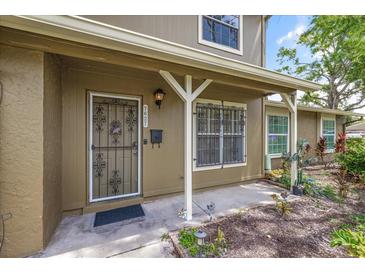 Charming home entrance with decorative security door and well-maintained landscaping at 7627 Deleon Ct, Tampa, FL 33615