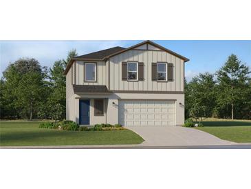 Charming two-story home featuring a two-car garage, well-manicured lawn, and inviting blue front door at 2278 Blue Grosbeak Pl, Wimauma, FL 33598