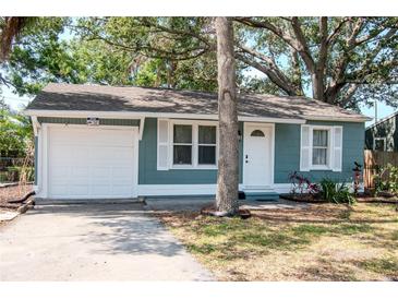 Charming single Gathering home with white trim, light blue siding and an attached garage at 2616 47Th N Ave, St Petersburg, FL 33714